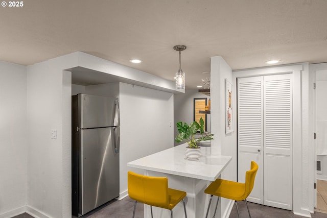 6945 SW 7th Ave, Portland, OR 97219 - kitchen with freestanding refrigerator, light countertops, recessed lighting, a peninsula, and decorative light fixtures