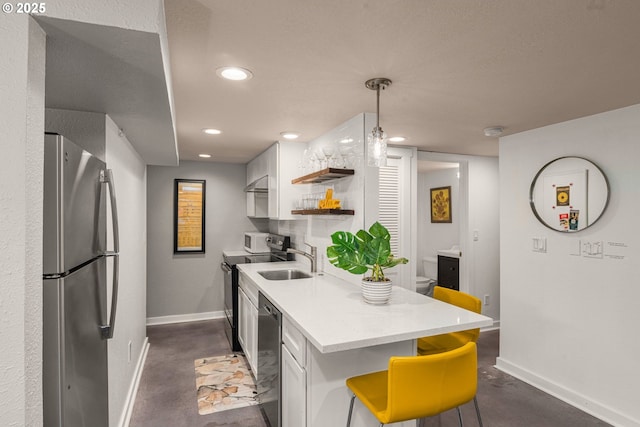 6945 SW 7th Ave, Portland, OR 97219 - kitchen featuring stainless steel appliances, finished concrete flooring, light countertops, open shelves, and recessed lighting