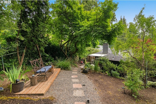 6945 SW 7th Ave, Portland, OR 97219 - view of yard featuring a wooden deck and view of wooded area