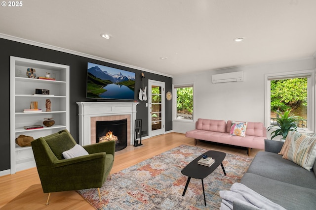 6945 SW 7th Ave, Portland, OR 97219 - living area featuring crown molding, a wall unit AC, wood finished floors, a fireplace with flush hearth, and recessed lighting