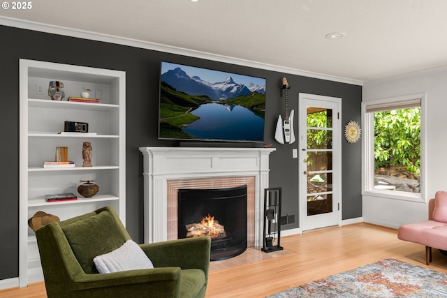 6945 SW 7th Ave, Portland, OR 97219 - living area featuring light wood finished floors, crown molding, a tile fireplace, and built in features