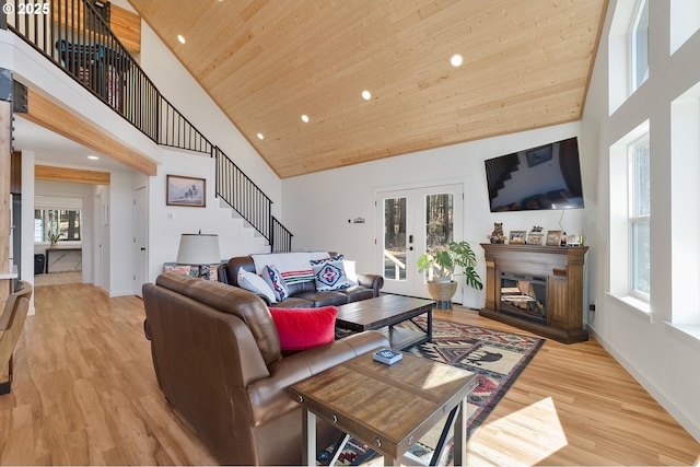 living area featuring wood ceiling, stairway, french doors, light wood-type flooring, and high vaulted ceiling