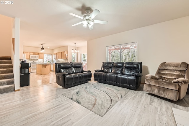 16371 SW Horseshoe Way, Beaverton, OR 97007 - living area with light wood finished floors, stairs, a chandelier, and a ceiling fan