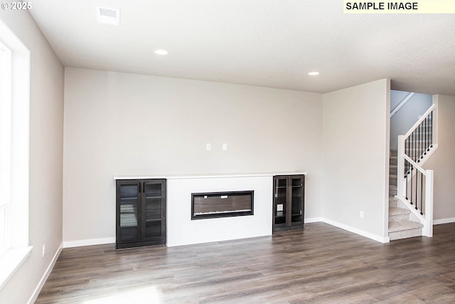 unfurnished living room featuring hardwood / wood-style floors