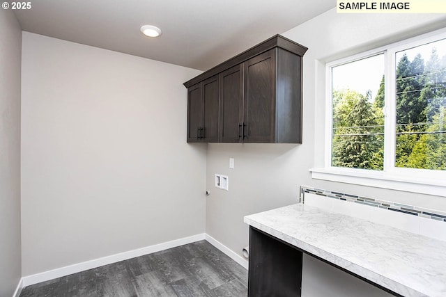 washroom with cabinets, hookup for a washing machine, and dark hardwood / wood-style flooring