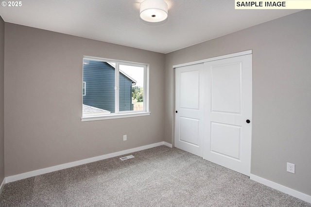 unfurnished bedroom with carpet and a closet