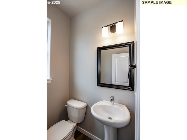 bathroom featuring sink and toilet