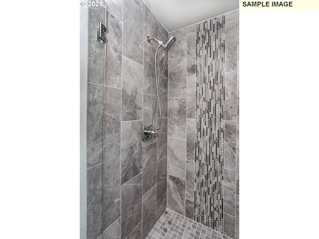 bathroom with a tile shower