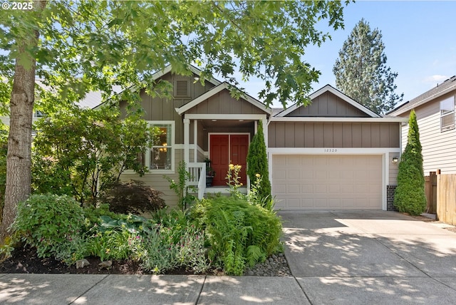 12320 SW Aspen Ridge Dr, Portland, OR 97224 - view of front facade with an attached garage, driveway, and board and batten siding