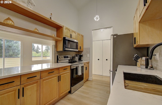 1611 NE 113th St, Vancouver, WA 98686 - kitchen with appliances with stainless steel finishes, decorative backsplash, light wood-style flooring, open shelves, and light brown cabinetry
