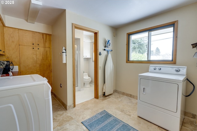 laundry area featuring washing machine and clothes dryer