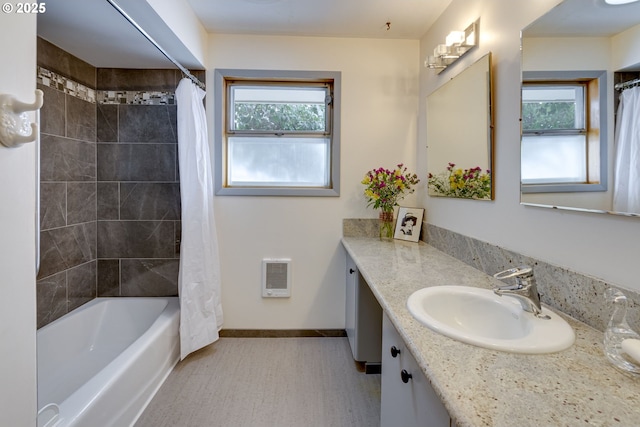 bathroom featuring vanity, plenty of natural light, and shower / tub combo