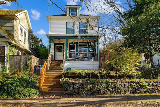 traditional style home featuring stairs, a porch, and fence