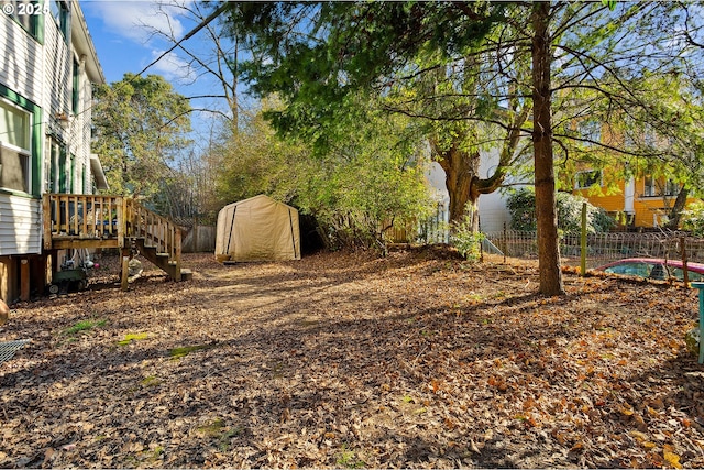 view of yard with stairs and fence