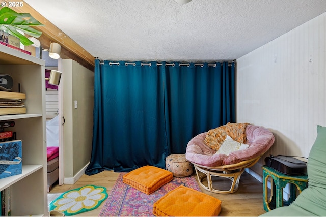 bedroom featuring light wood-type flooring and a textured ceiling