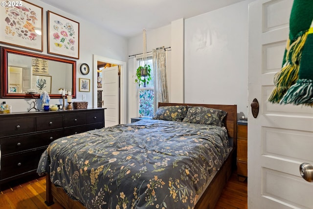 bedroom with dark wood finished floors