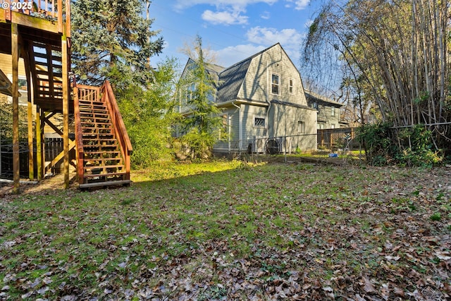 view of yard with stairs and a fenced backyard