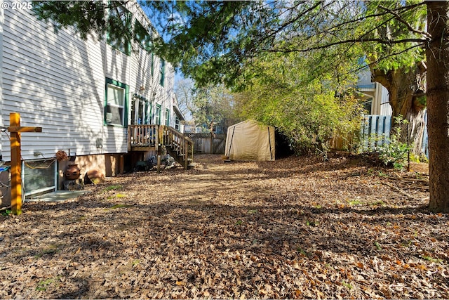 view of yard featuring fence and a shed