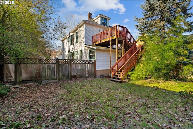 back of property featuring stairs, a deck, a chimney, and fence