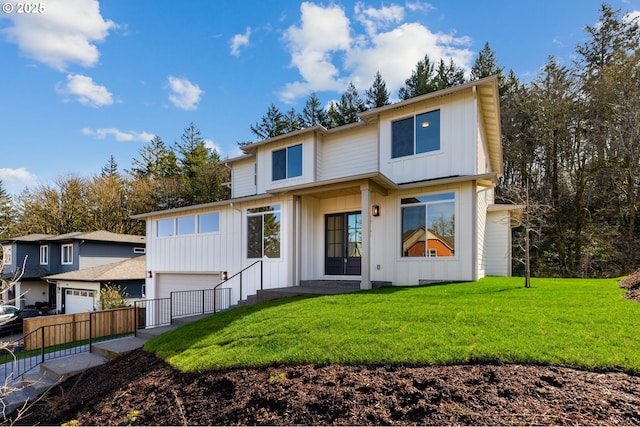 view of front of property with a garage, board and batten siding, and a front yard