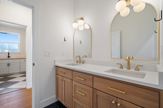 full bathroom with double vanity and a sink