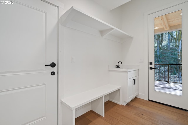 mudroom with light wood-style floors and a sink