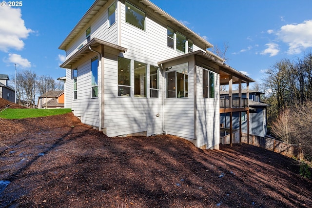 view of side of home with a sunroom