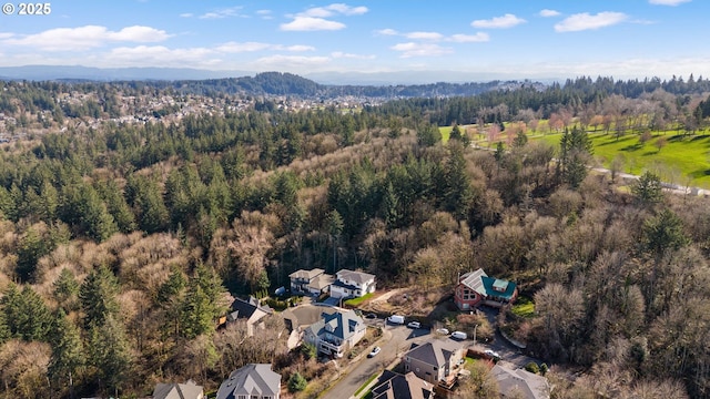 birds eye view of property featuring a view of trees