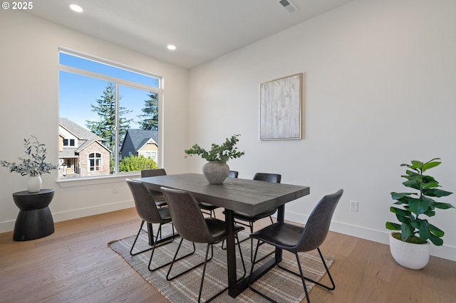 dining area with recessed lighting, baseboards, and light wood finished floors