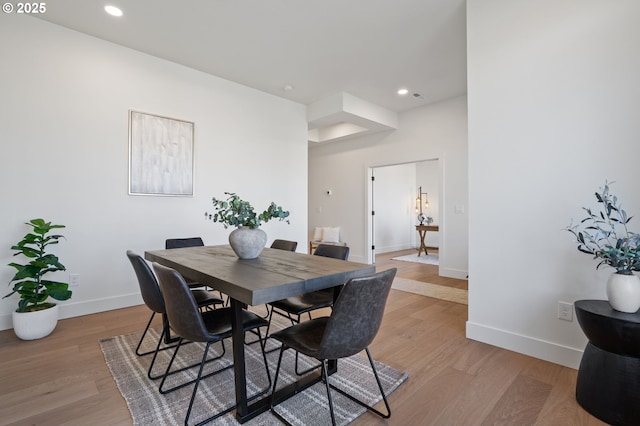 dining room featuring recessed lighting, light wood-type flooring, and baseboards