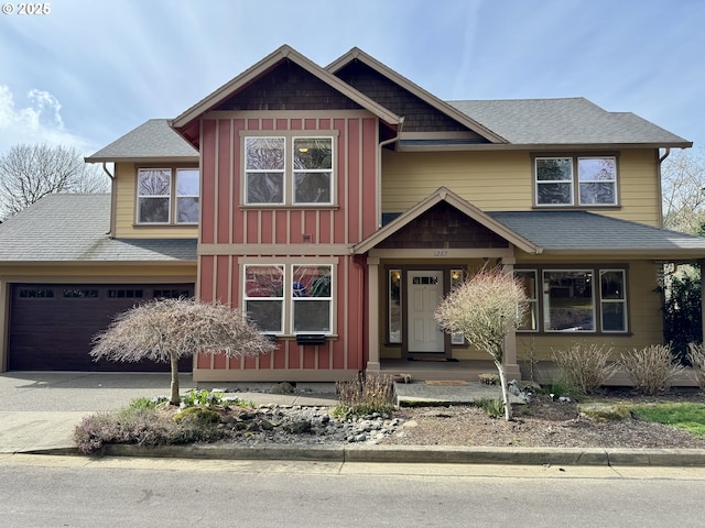 view of front of home featuring board and batten siding, driveway, a shingled roof, and a garage