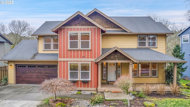 craftsman-style home featuring driveway, board and batten siding, and roof with shingles