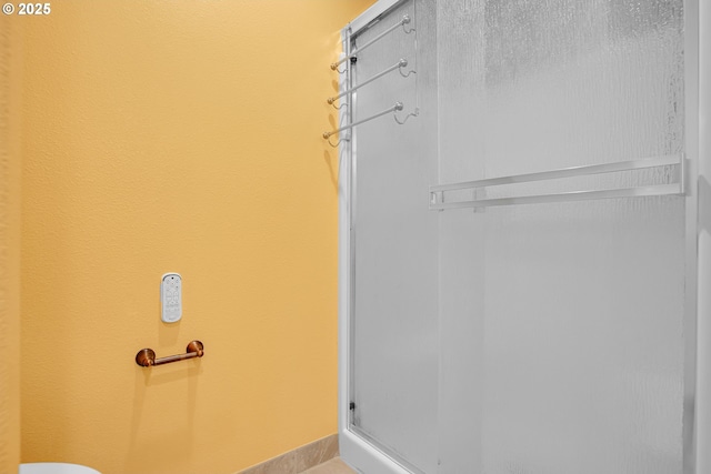 bathroom with baseboards and an enclosed shower