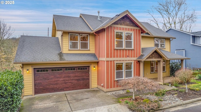 view of front of home with driveway, board and batten siding, and roof with shingles