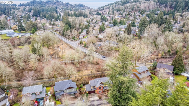 birds eye view of property featuring a residential view and a wooded view