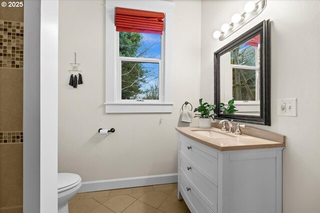 bathroom with tile patterned flooring, vanity, and toilet