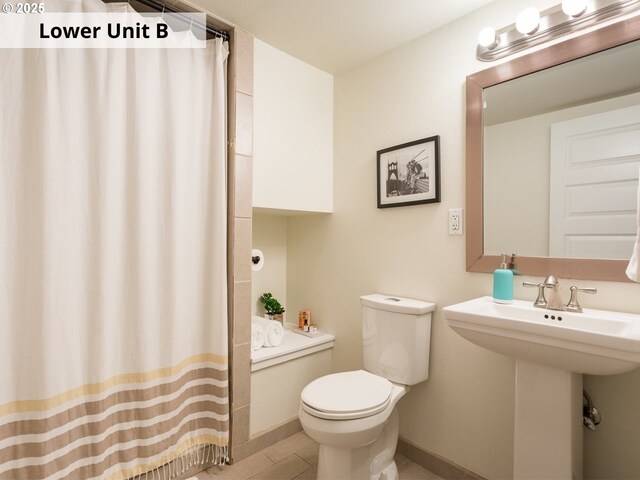 bathroom with toilet and walk in shower