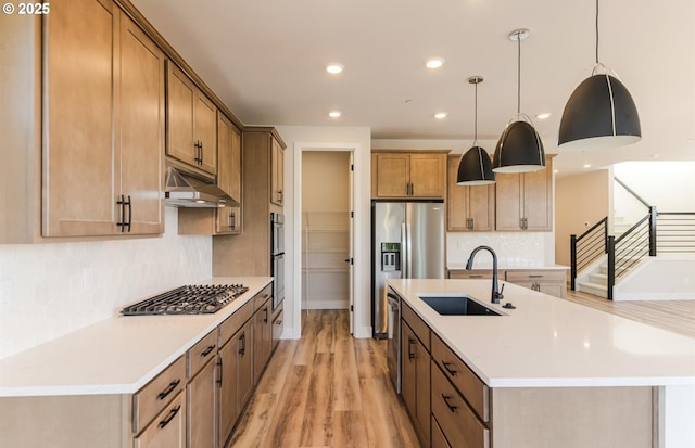 17437 NW Antonio St, Portland, OR 97229 - kitchen with a sink, under cabinet range hood, light wood-style flooring, decorative backsplash, and recessed lighting
