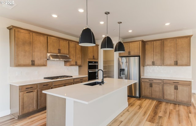 17437 NW Antonio St, Portland, OR 97229 - kitchen with stainless steel refrigerator with ice dispenser, a sink, under cabinet range hood, gas stovetop, and brown cabinetry