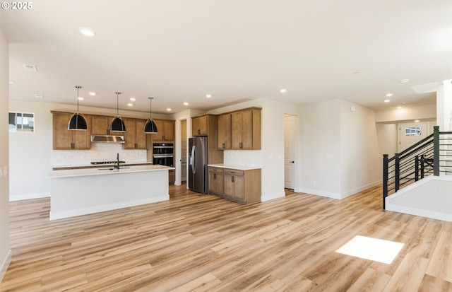 17437 NW Antonio St, Portland, OR 97229 - kitchen featuring stainless steel fridge, baseboards, recessed lighting, brown cabinets, and light countertops