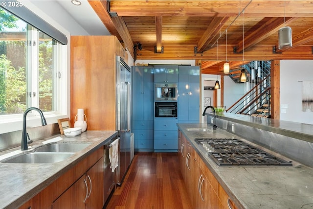 4183 SW Greenleaf Dr, Portland, OR 97221 - kitchen featuring a sink, wooden ceiling with exposed beams, appliances with stainless steel finishes, dark wood-style floors, and plenty of natural light