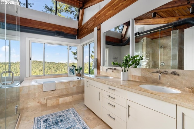 4183 SW Greenleaf Dr, Portland, OR 97221 - bathroom with double vanity, a stall shower, a bath, and wooden ceiling with exposed beams