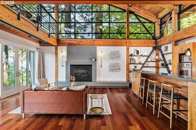 4183 SW Greenleaf Dr, Portland, OR 97221 - living room featuring high vaulted ceiling, a glass covered fireplace, and wood finished floors