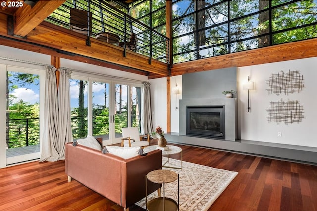 4183 SW Greenleaf Dr, Portland, OR 97221 - living room with a high ceiling, wood finished floors, plenty of natural light, and a glass covered fireplace