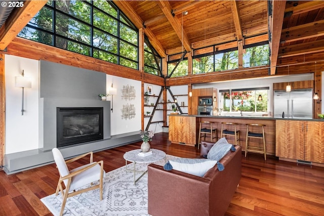 4183 SW Greenleaf Dr, Portland, OR 97221 - living area featuring high vaulted ceiling, wood ceiling with exposed beams, a glass covered fireplace, healthy amount of natural light, and wood finished floors