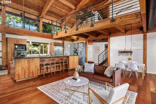 4183 SW Greenleaf Dr, Portland, OR 97221 - living room with wood ceiling with exposed beams, high vaulted ceiling, stairway, and wood finished floors