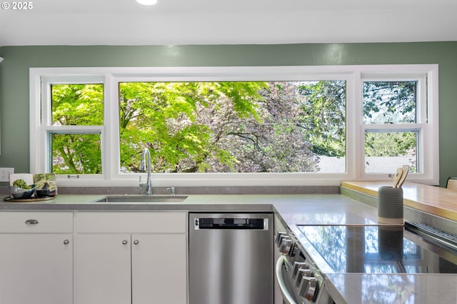 8075 SW Valley View Ct, Portland, OR 97225 - kitchen with appliances with stainless steel finishes, recessed lighting, white cabinetry, light wood-type flooring, and light countertops