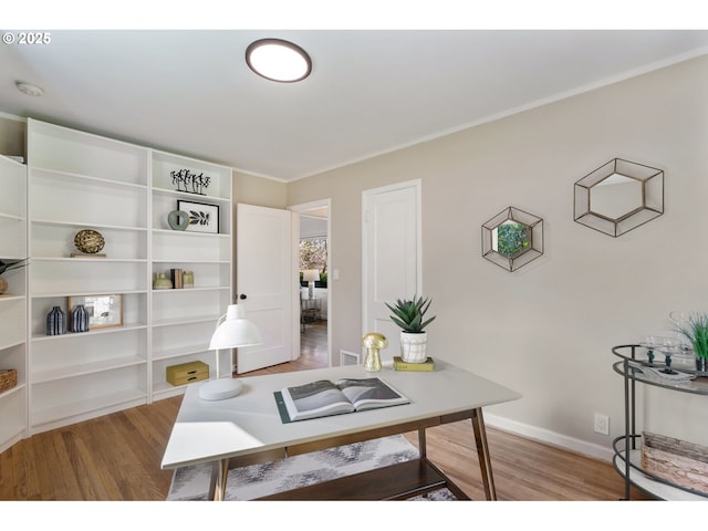 interior space featuring baseboards, light wood finished floors, and visible vents