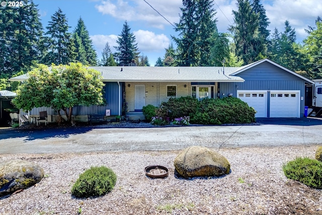16828 Webster Rd, Gladstone, OR 97027 - ranch-style house with a garage, driveway, board and batten siding, and brick siding
