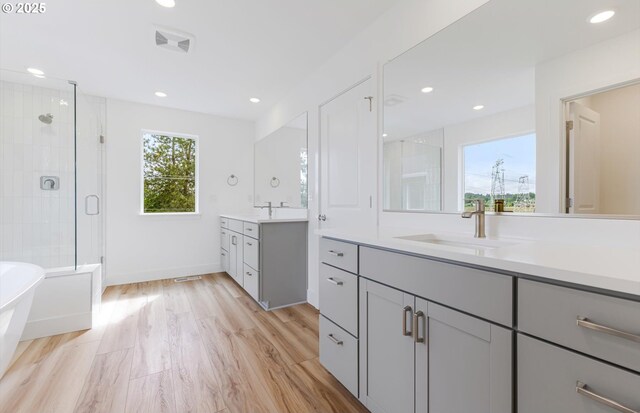 27226 SW Yarrow Ln, Wilsonville, OR 97070 - full bathroom with a shower stall, two vanities, a soaking tub, recessed lighting, and baseboards